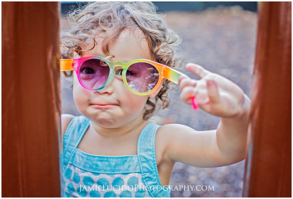 child playing, sunglasses, playful photography, colorful portrait