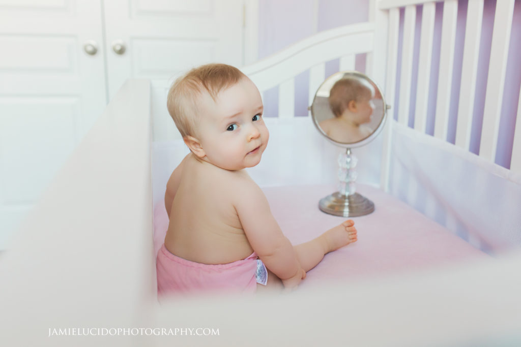 baby in crib with mirror lifestyle session