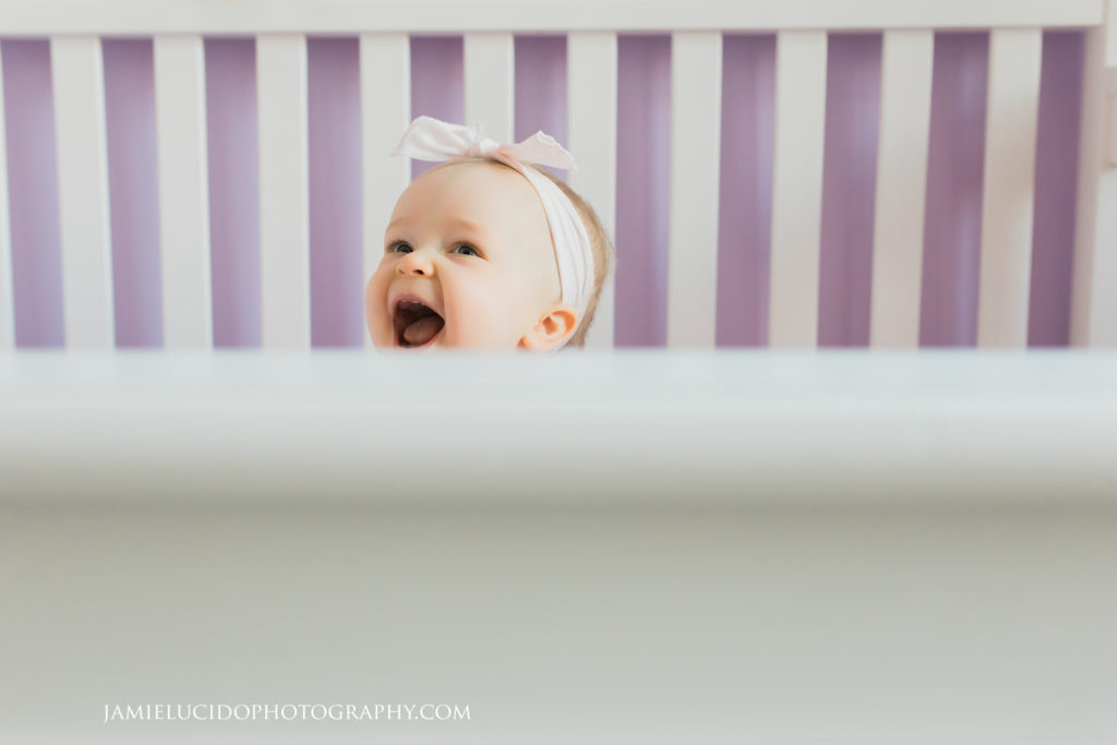 lifestyle session baby laughing in crib