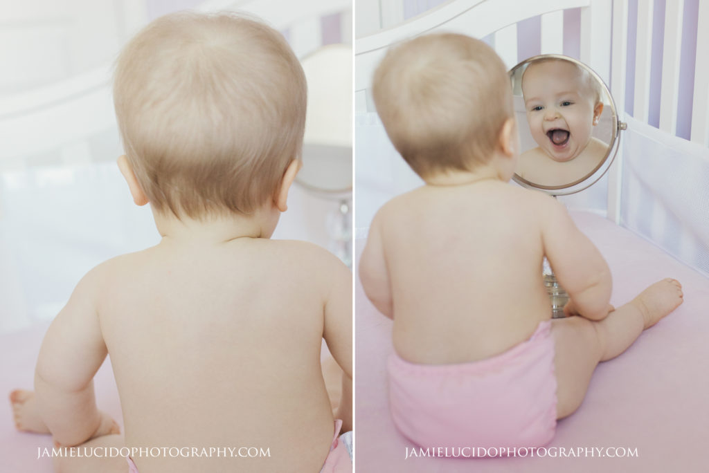 baby laughing at mirror in crib