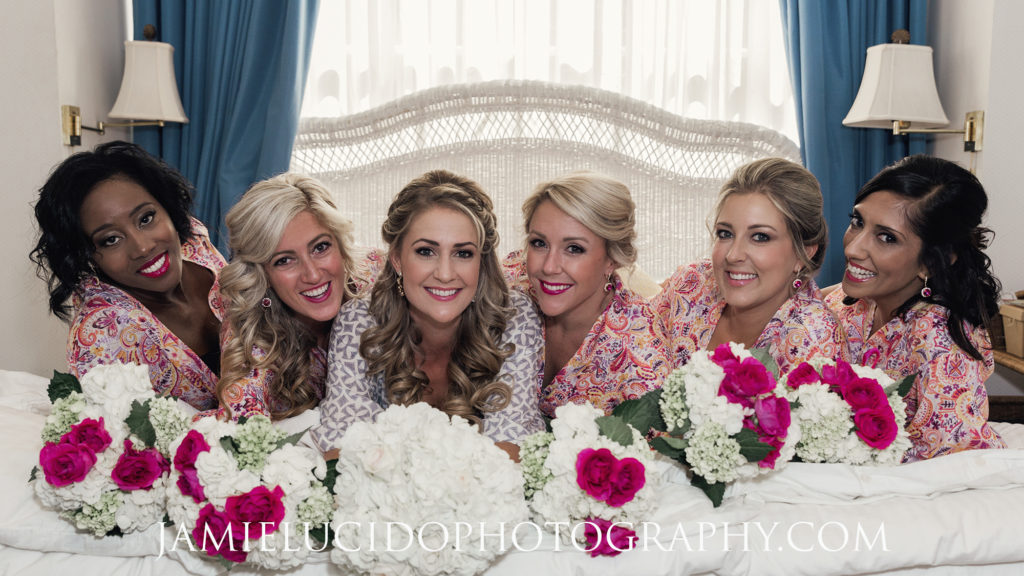 bride and bridesmaids on bed