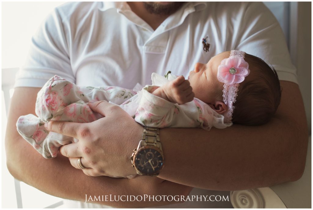 father holding newborn, father daughter, lifestyle photography, family photography, natural light, in home photography