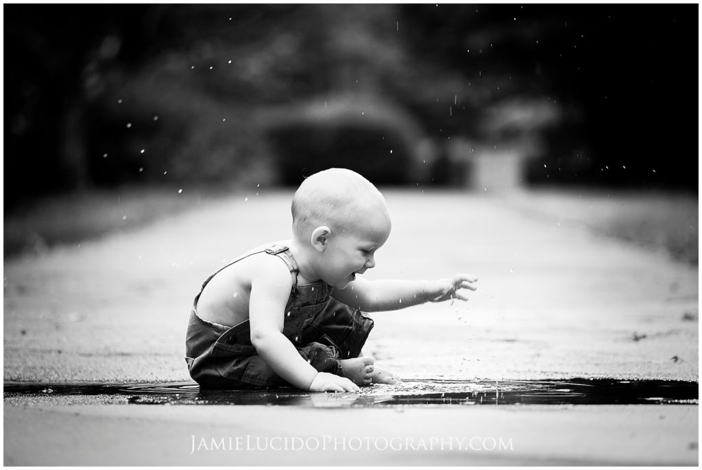 black and white photography, baby milestones, milestone photography, playful photography, splash in puddles, family documentary, charlotte documentary photographer, charlotte photo journalism, family photo journalism