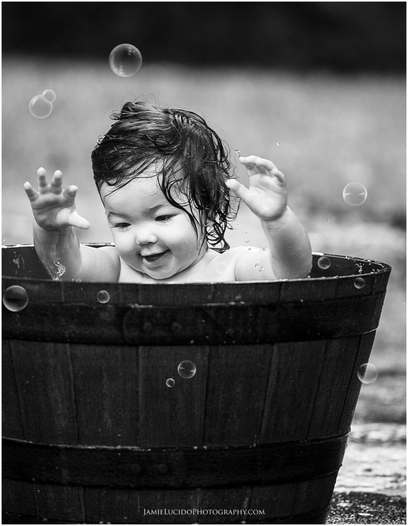 documentary bath, baby bath, documentary photographer, black and white photography, first birthday, bubble bath outside, family photographer