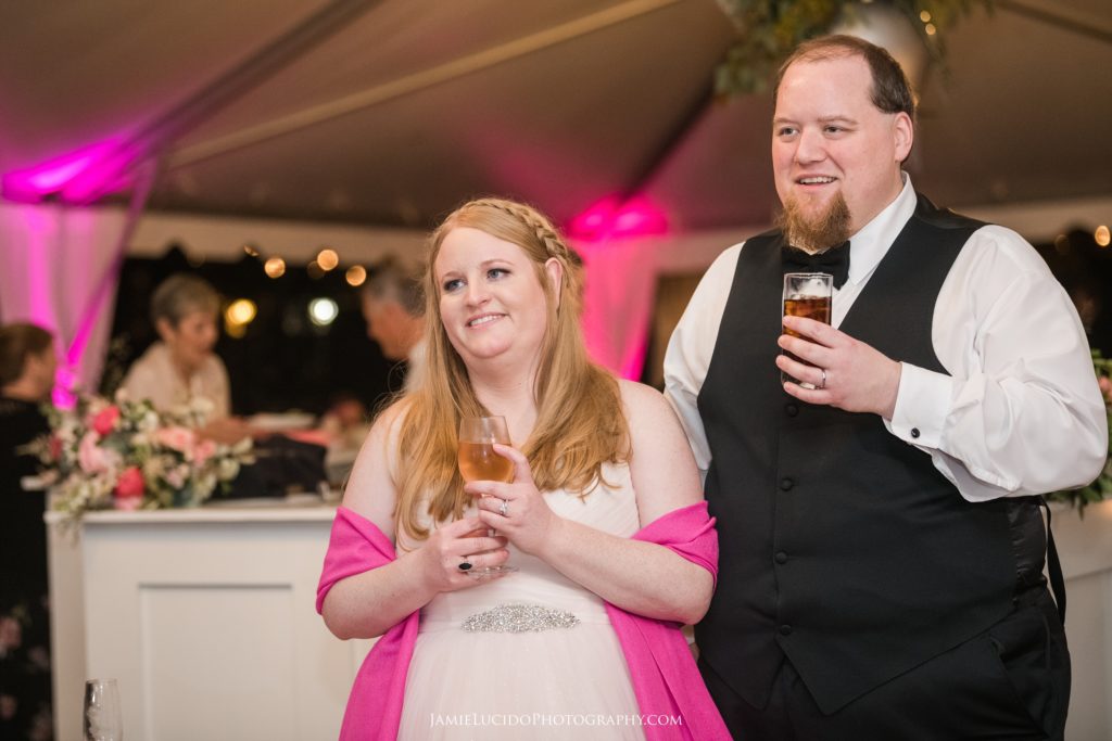 reception toasts, wedding toast, bride and groom listen to toasts